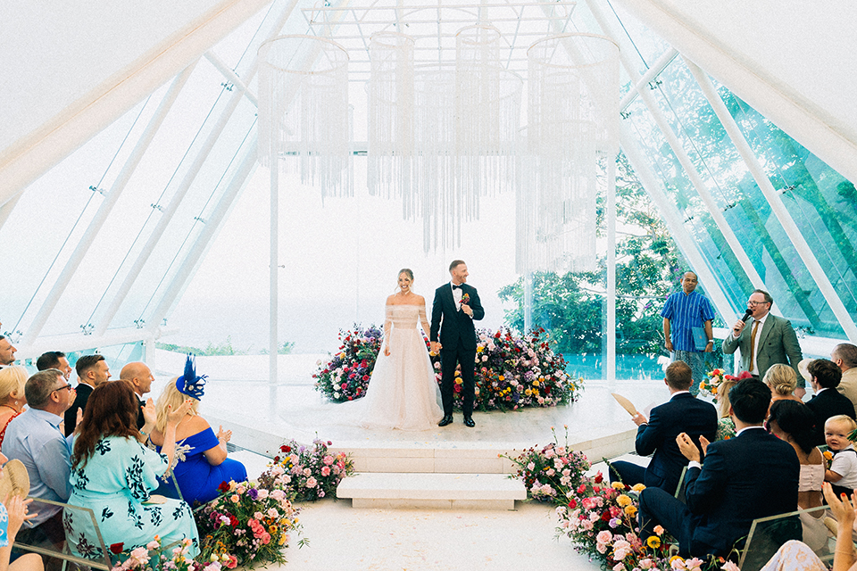 Emotional wedding ceremony at Tirtha Bali glass chapel ocean view