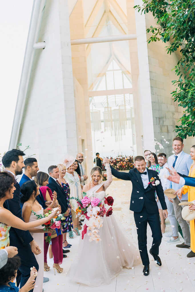 best uluwatu wedding venues bali flower shower couple exit ceremony aisle ocean view guests celebration
