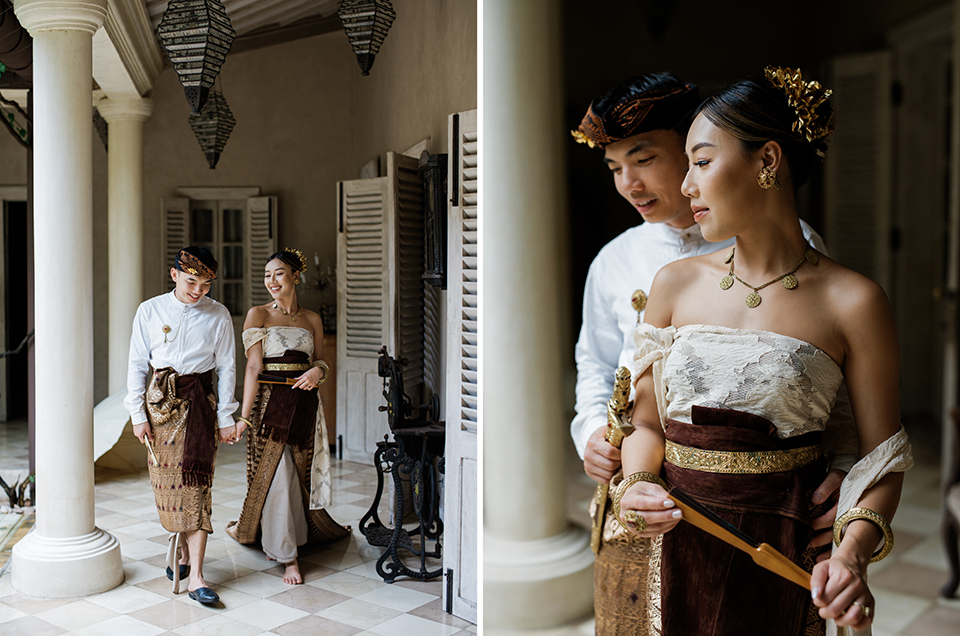 Bali couple photoshoot at Balquisse Heritage Hotel with couple in traditional Balinese outfit walking through elegant heritage corridor