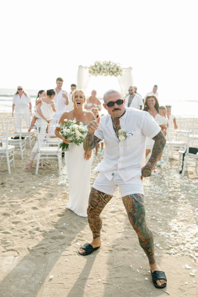 fun bali beach elopement couple running joyful wedding moment candid photography