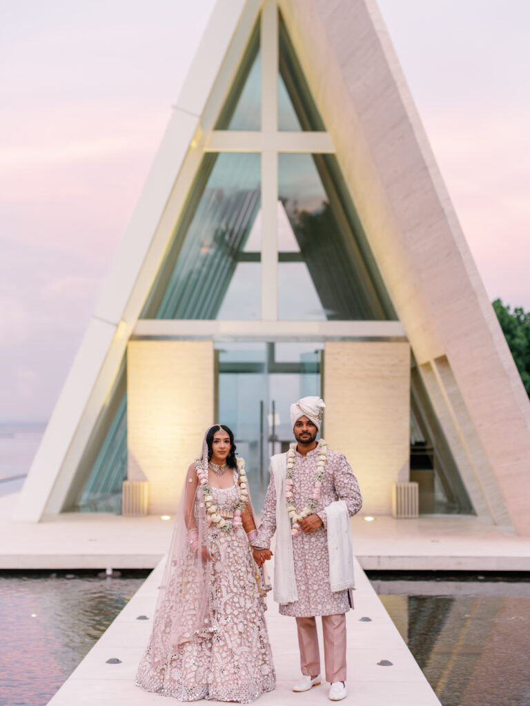 Indian wedding in Bali at Conrad Bali with couple in front of chapel during sunset