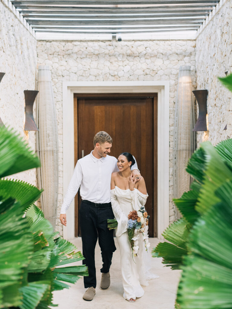 Couple walking naturally through Bali venue — comfort built before wedding day shows in every frame, documentary wedding photographer Bali