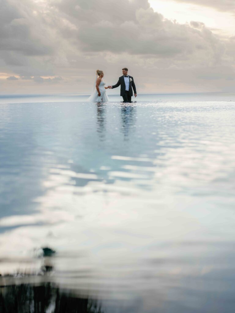 Luxury Bali wedding couple portrait at infinity pool — how to choose a wedding photographer in Bali who delivers consistently at every price point