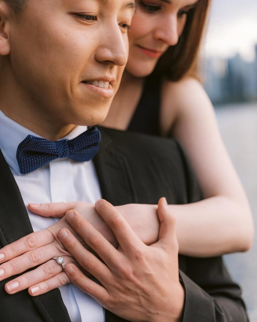 Engagement ring detail — Amanda's hand resting on Tony's chest during Stanley Park couple session
