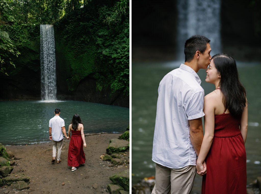 Couple walking and embracing at Tibumana Waterfall during a Bali 2 hour couple photoshoot surrounded by lush jungle