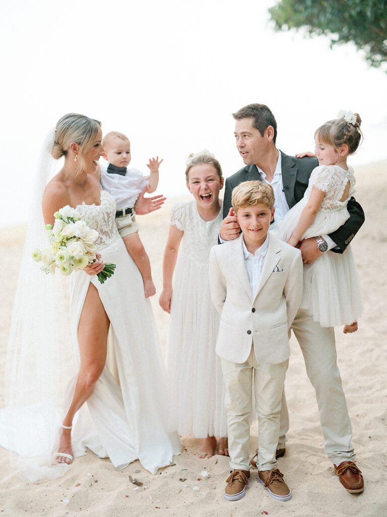 samabe bali elopement with family candid beach wedding moment with children barefoot sand