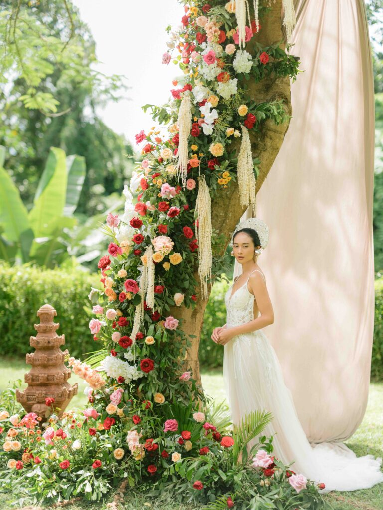 Editorial bridal portrait Bali — fine art wedding photography with floral ceremony backdrop, deliberate composition before getting ready