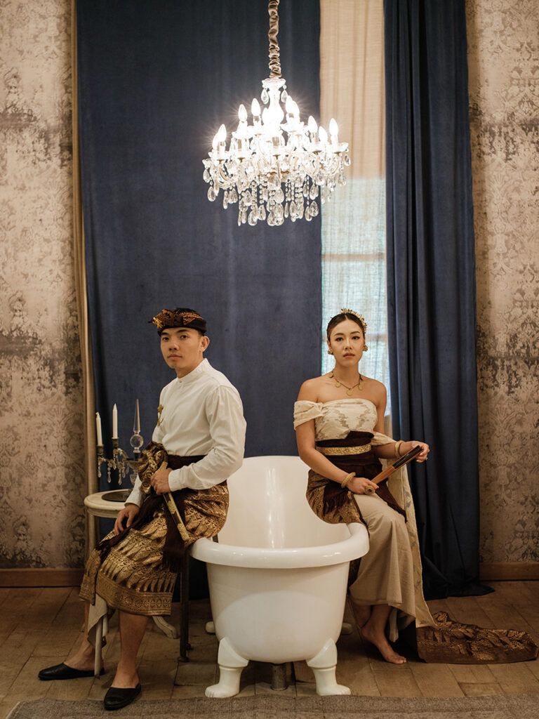 Bali heritage couple photoshoot with traditional inspired outfit at Balquisse Hotel featuring elegant indoor vintage setting