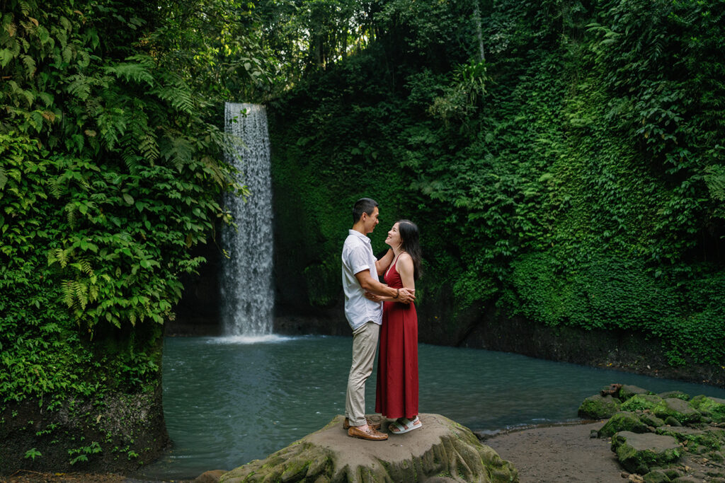 Couple photoshoot at Tibumana Waterfall in Bali during a relaxed 2 hour session surrounded by lush jungle and flowing water