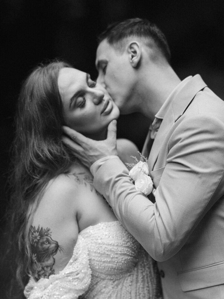 Intimate black and white portrait of couple kissing during Bali elopement