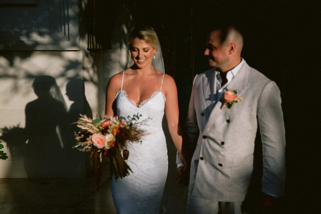 Aimee and Blake walking together during their Bali wedding experience in soft natural light