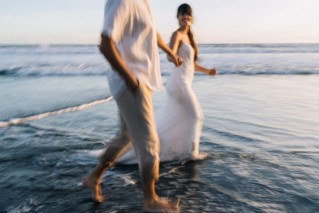 Sunset couple session Uluwatu Bali cliffside beach floral dress
