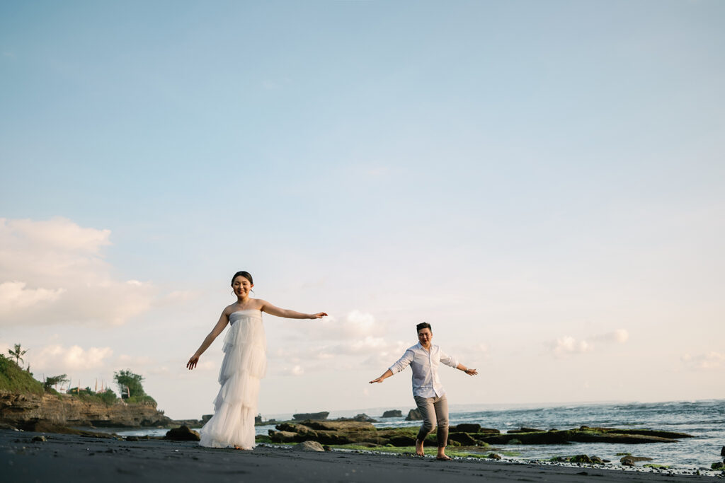 Canggu couple photoshoot Bali black sand beach natural movement candid