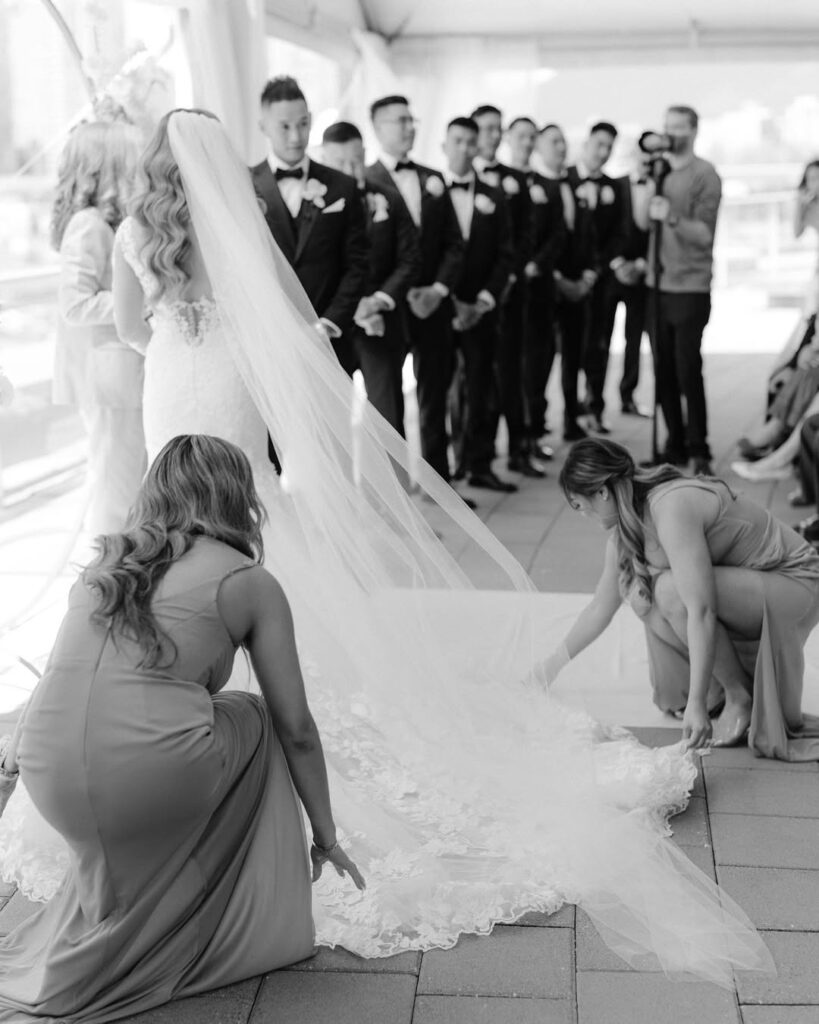 Bridesmaids arranging veil before wedding ceremony — documentary wedding photography Vancouver, candid moment not found in Instagram highlights