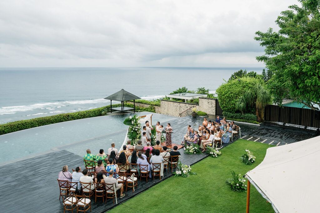 Lauren Dan wedding in Uluwatu Bali ceremony at Pandawa Cliff overlooking ocean during cloudy day