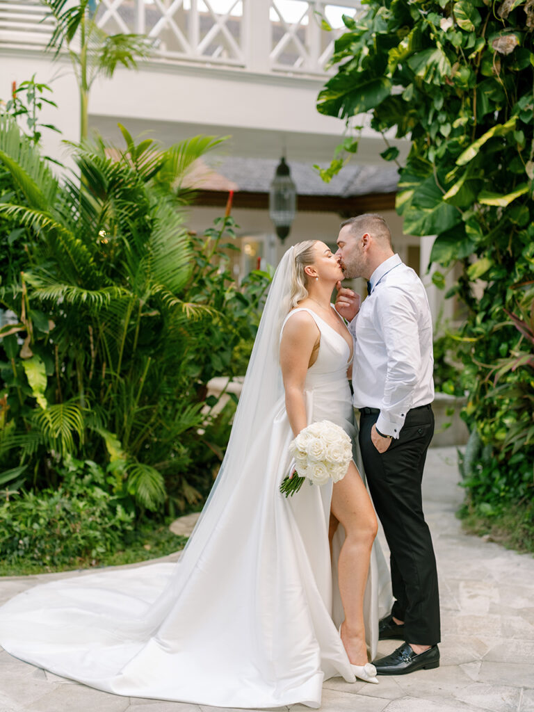 intimate villa wedding in Bali couple kissing in tropical garden setting