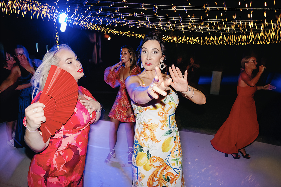 intimate villa wedding in Bali dance party with guests celebrating under string lights