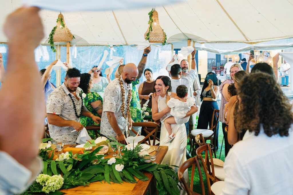 Lauren Dan wedding in Uluwatu Bali reception celebration at Pandawa Cliff with guests cheering and dancing