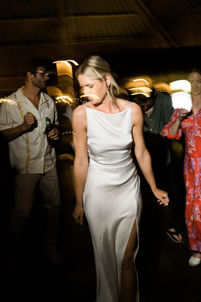 documentary wedding photographer bali bride dancing reception candid unscripted motion blur coverage