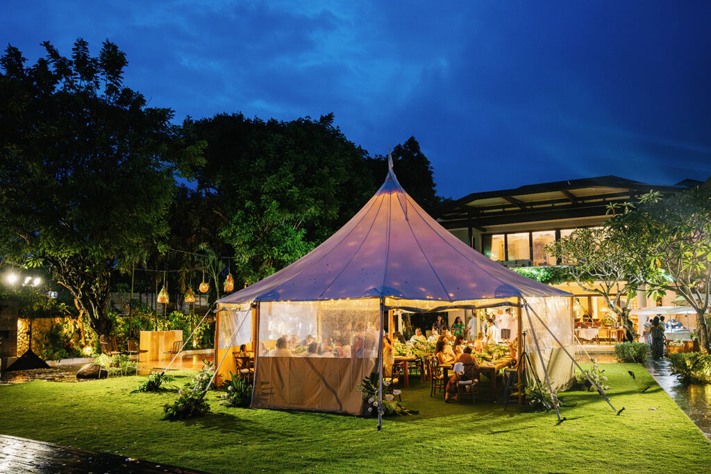 Lauren Dan wedding in Uluwatu Bali reception at Pandawa Cliff under tent with warm lights at night