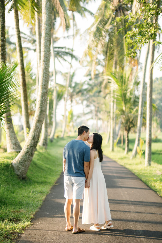 Ubud couple photoshoot Bali palm tree lined path morning golden light
