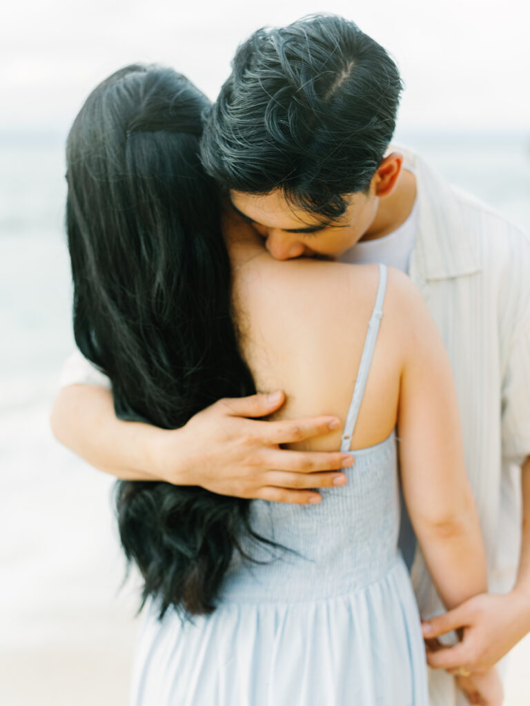 Sunset couple session Uluwatu Bali limestone cliff beach candid