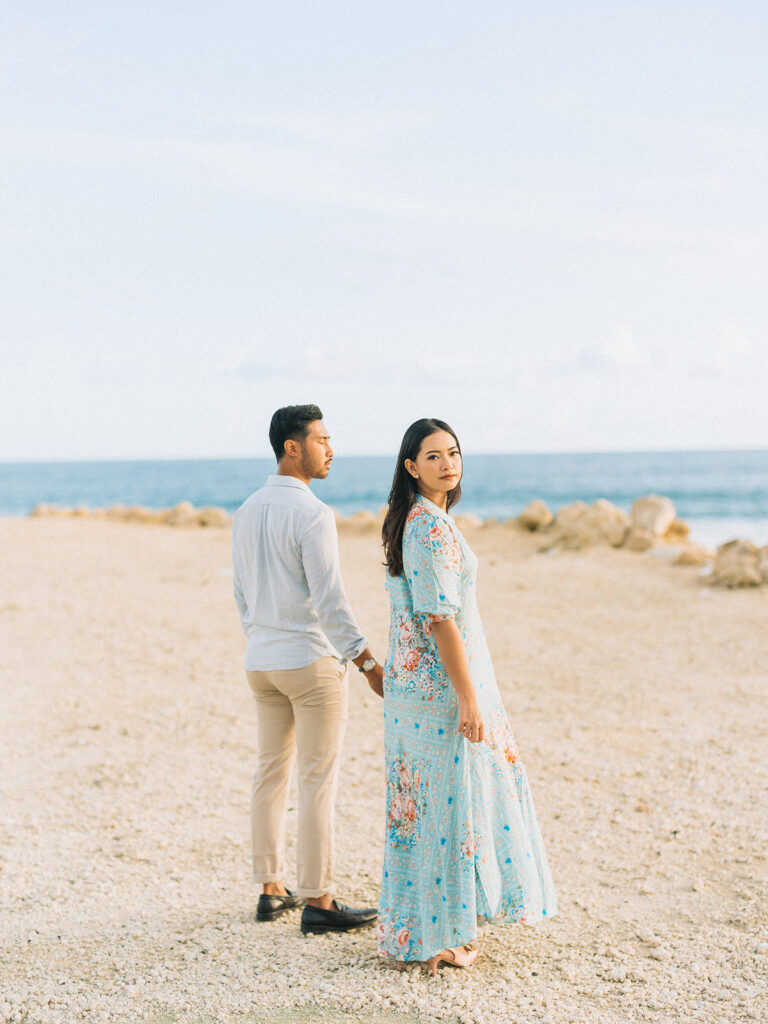 Sunset couple session Uluwatu Bali beach cliff running waves natural