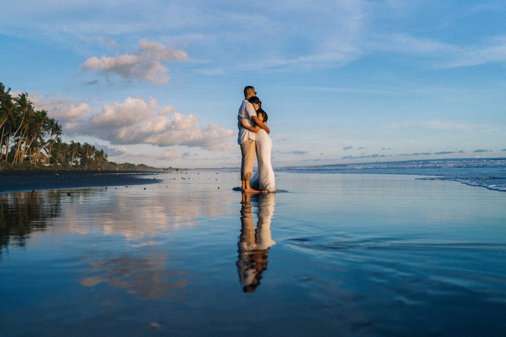 Canggu couple photoshoot Bali black sand beach reflection blue sky