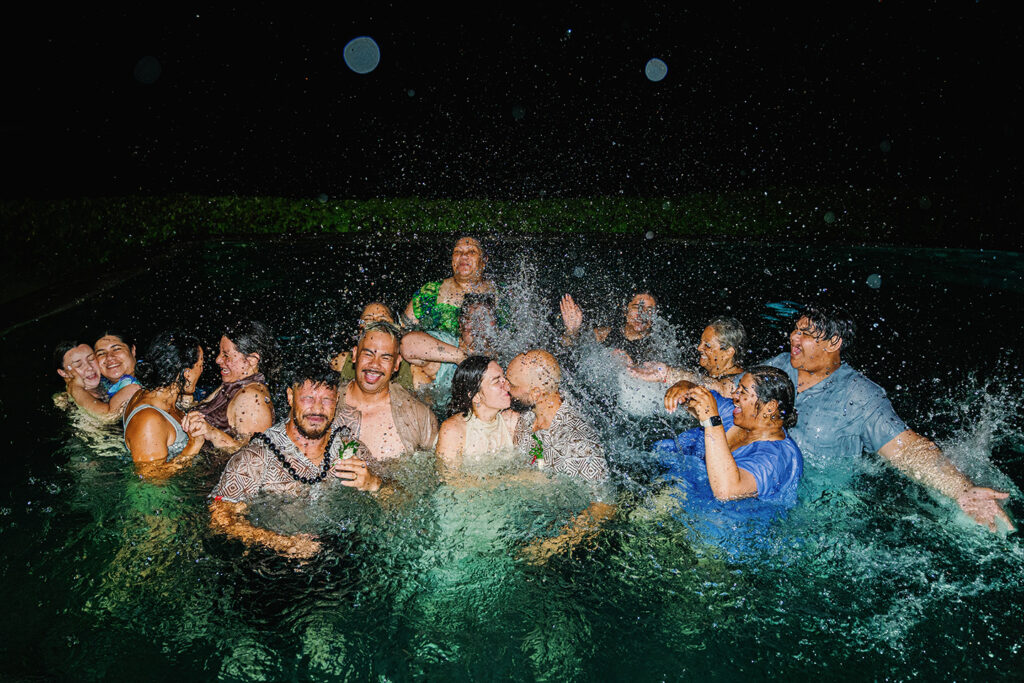 Lauren Dan wedding in Uluwatu Bali pool party celebration at Pandawa Cliff with guests jumping into water at night