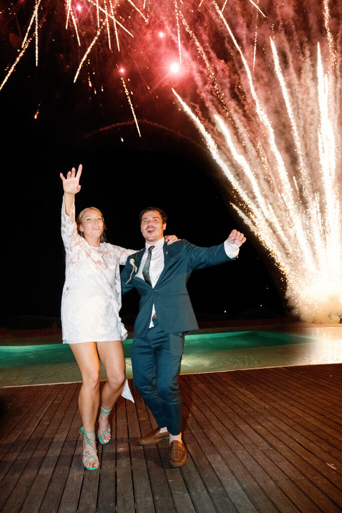 Wonderland Uluwatu wedding fireworks with bride and groom celebrating at night in Bali