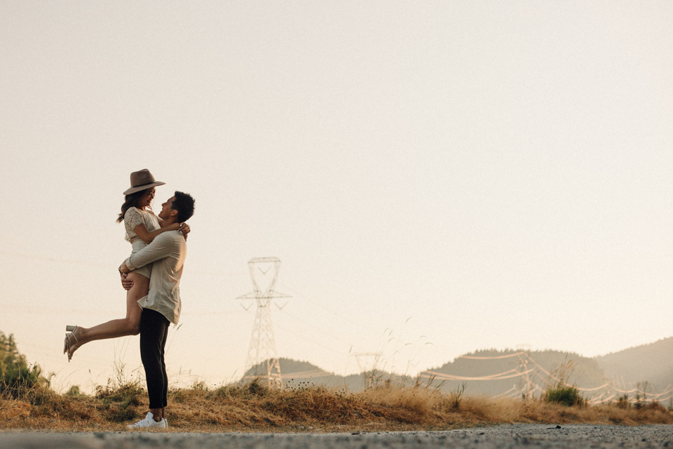 Dave lifting Winnie at golden hour — warm light Fraser Valley British Columbia