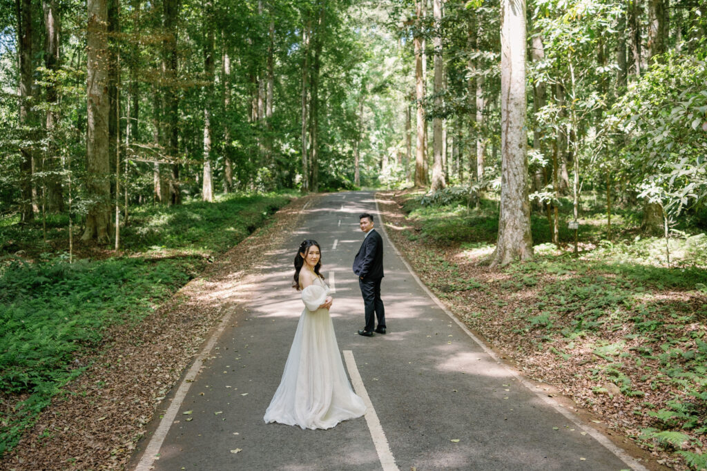 Bali couple photoshoot for Singapore couples in a forest road with natural light
