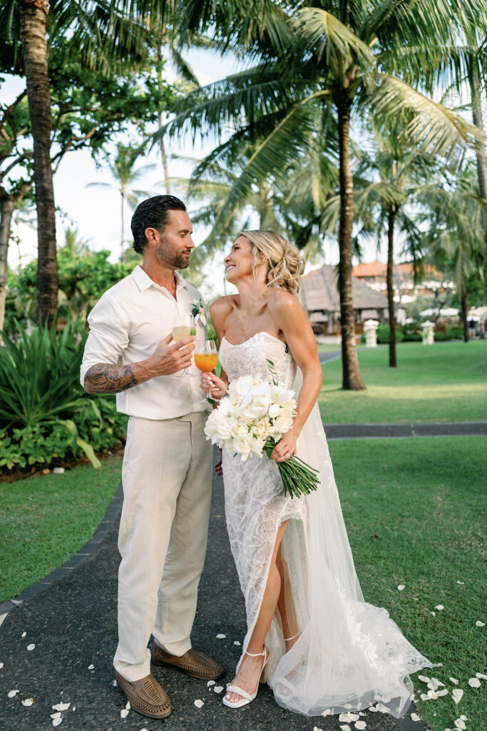 Portrait Session — Garden walk post-ceremony Alt text: Bride and groom walking through tropical garden at Nusa Dua Beach Hotel Bali after wedding ceremony — Luxima Wedding photography