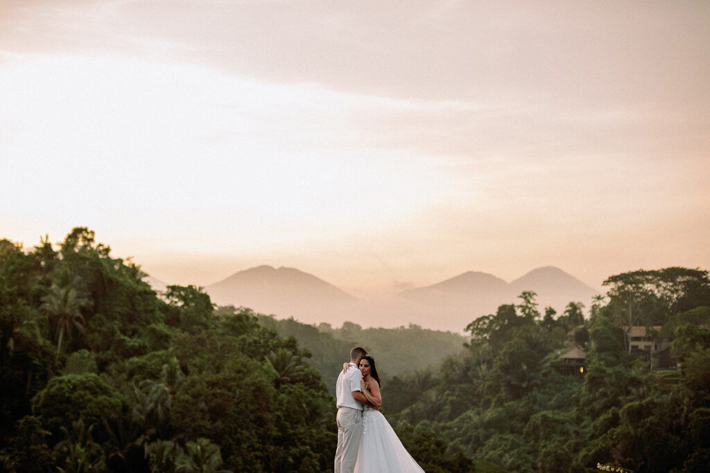 Bride and groom at sunset overlooking Ubud jungle valley and mountains at Puri Wulandari Bali — Luxima Wedding photography