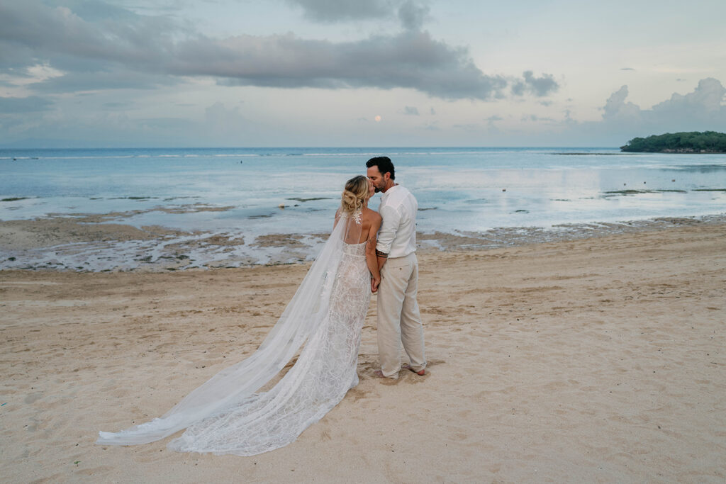 Portrait Session — Beach at dusk Alt text: Bride and groom on beach at dusk after Nusa Dua Beach Hotel wedding Bali — natural light wedding photography by Luxima Wedding