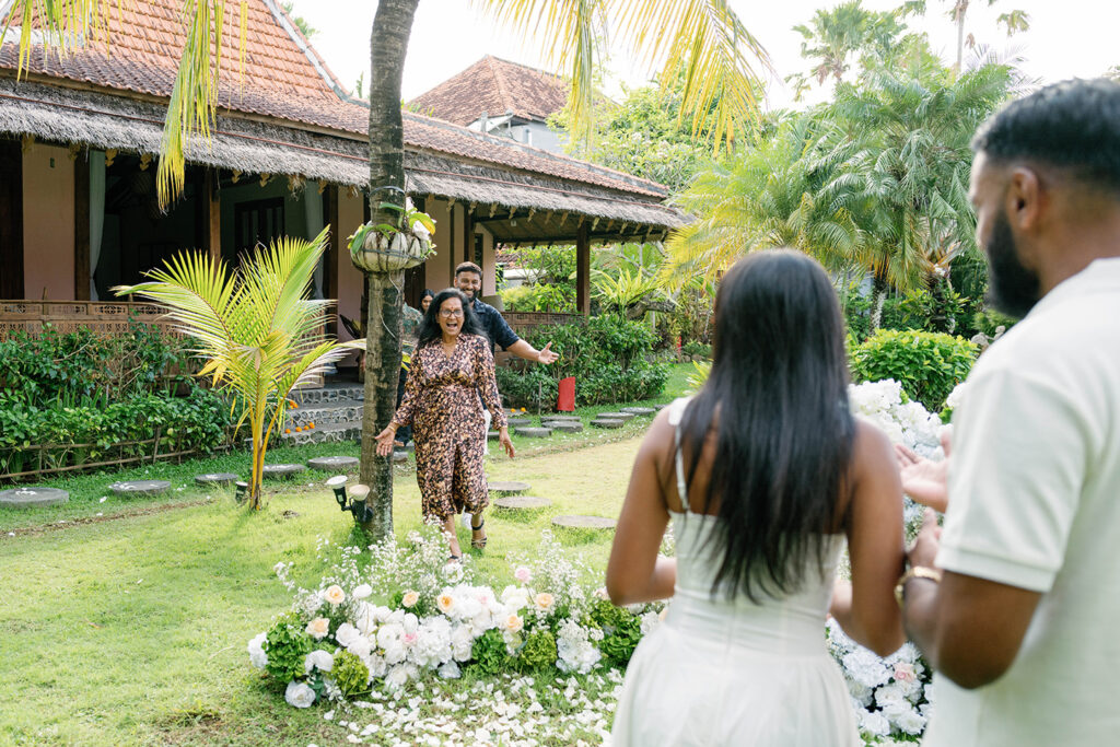 Emotional moment as family members surprise the newly engaged couple during a proposal celebration at Villa Desa Roro Bali