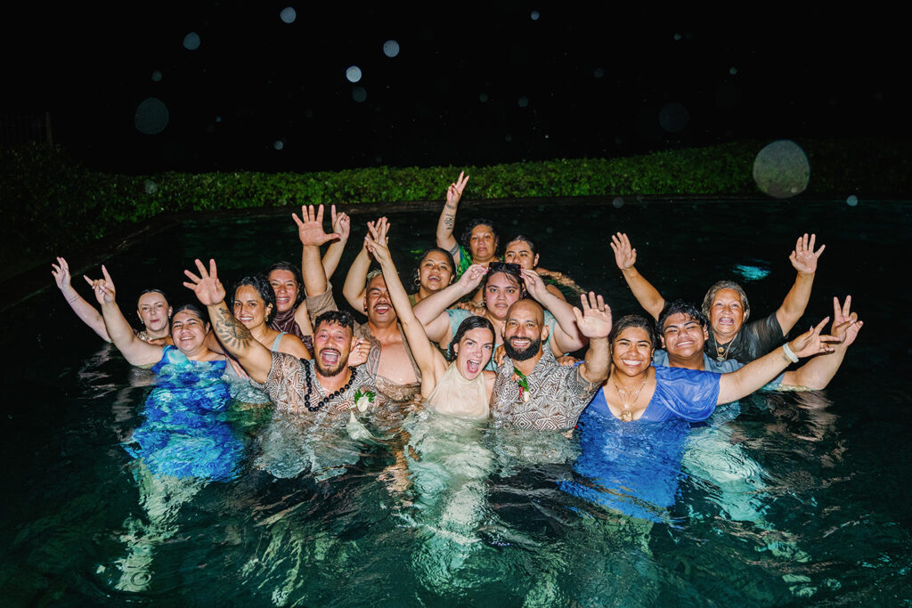 Wedding guests celebrating in the pool at a Bali villa wedding reception