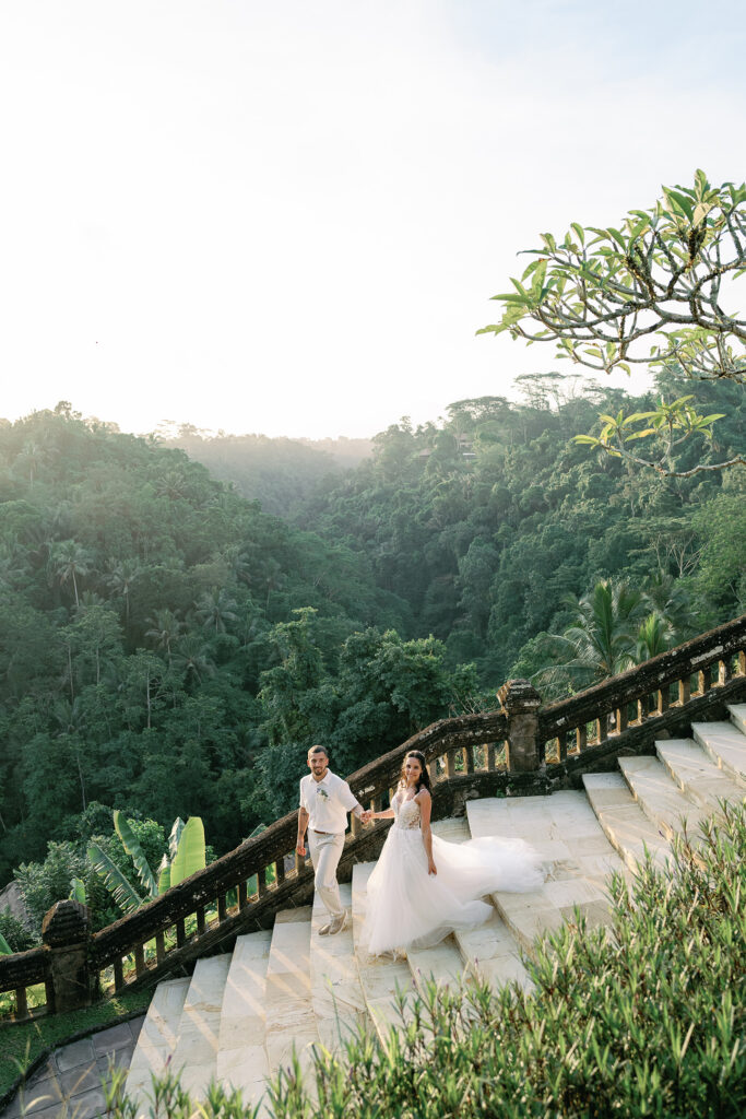 Intimate elopement ceremony at Puri Wulandari Ubud with purple floral arch and Ayung River valley backdrop — Luxima Wedding photography