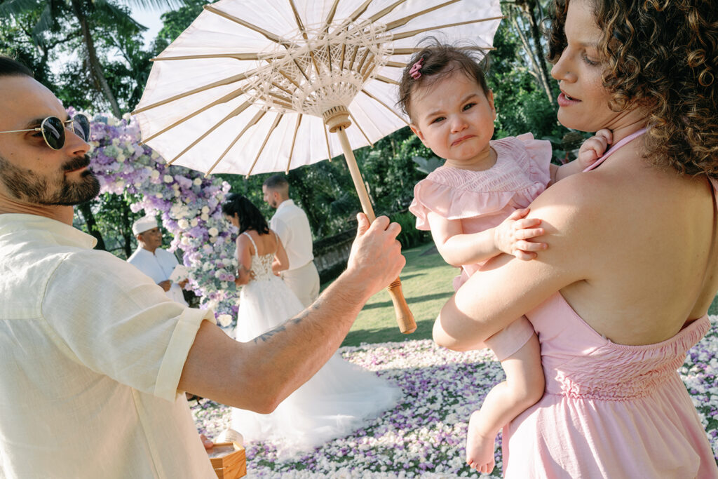 Candid moment with baby during intimate wedding ceremony at Puri Wulandari Ubud Bali — documentary photography by Luxima Wedding