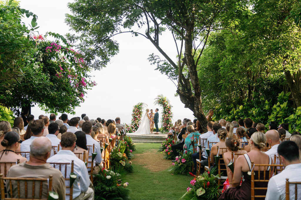 Full wedding ceremony at Uluwatu clifftop venue with ocean backdrop, Bali