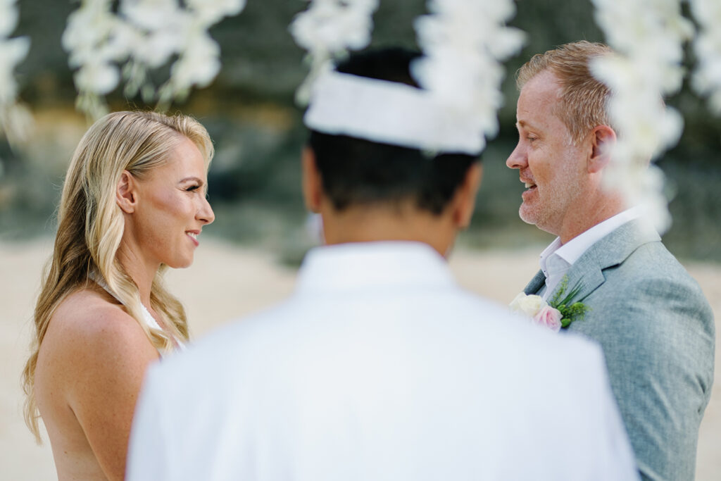 Bride and groom exchanging vows during Melasti Beach elopement at 7am — Luxima Wedding
