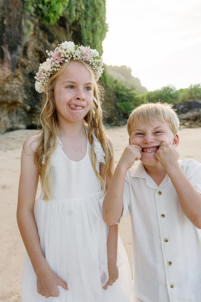 Children making funny faces at Melasti Beach during family elopement Bali — Luxima Wedding photography