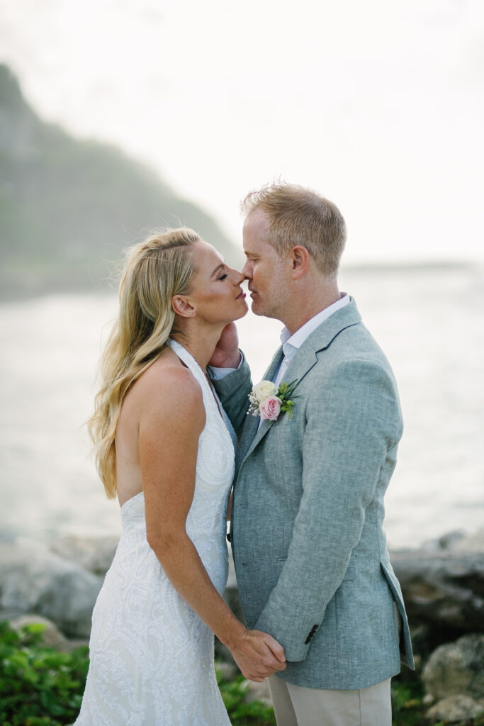 Couple portrait kiss at Melasti Beach Bali during elopement — ocean and cliffs backdrop — Luxima Wedding