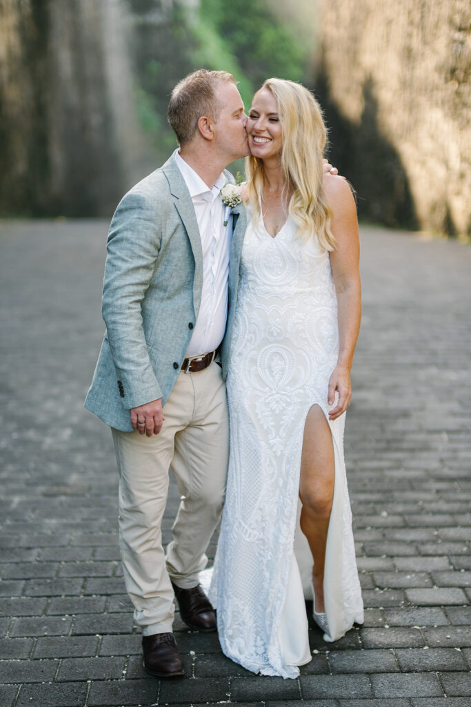 Bride and groom couple portrait in Melasti Beach canyon — Bali elopement photography by Luxima Wedding