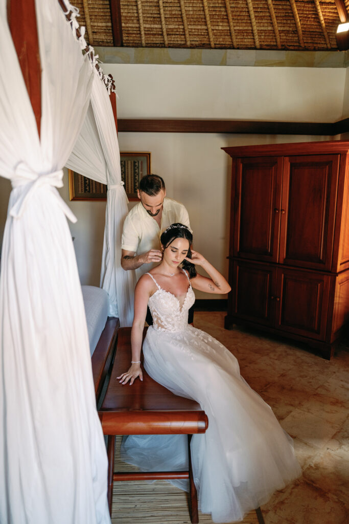 Luis helping Micaela with her earrings during getting ready at Puri Wulandari villa Ubud Bali — Luxima Wedding photography
