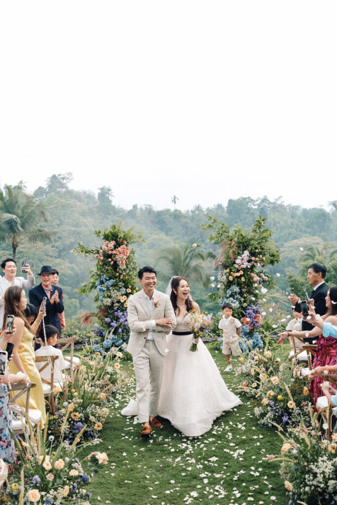 Terry and Jimmy walking back down the aisle at Padma Resort Ubud wedding ceremony — jungle fog Ubud Bali wedding photographer