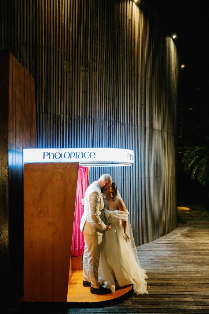 Janela and Jack kissing at Peppers Seminyak photo booth during wedding reception Bali