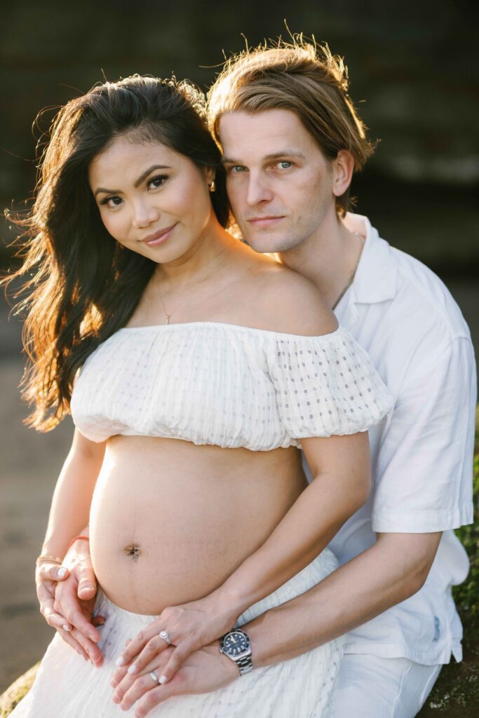 Elly and Tom portrait maternity session Nyanyi Beach Bali cliff rock formation