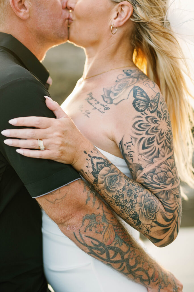 Close up of Kaytie and Jamie kissing showing tattoo sleeve detail during Bali vow renewal — Luxima Wedding
